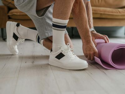 Close-up of a yoga mat on a wooden floor.