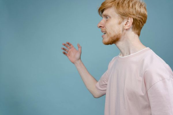 Person focused on movement in a minimalist bright room.